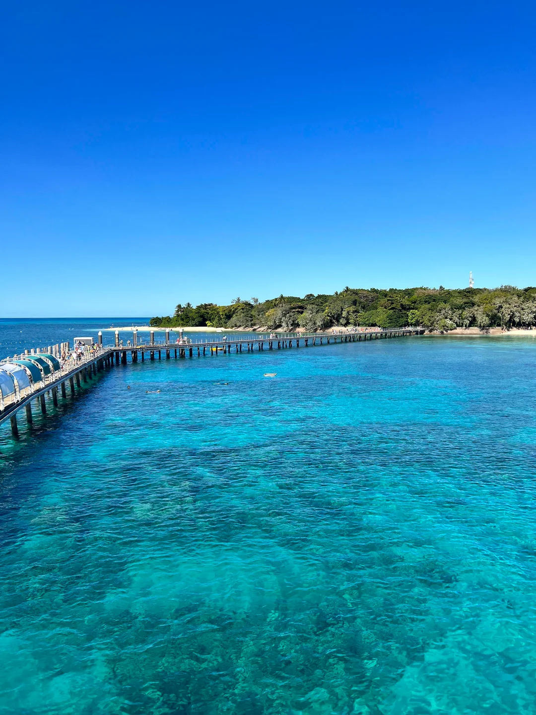 Green Island pier stretching over crystal-clear turquoise water, Cairns