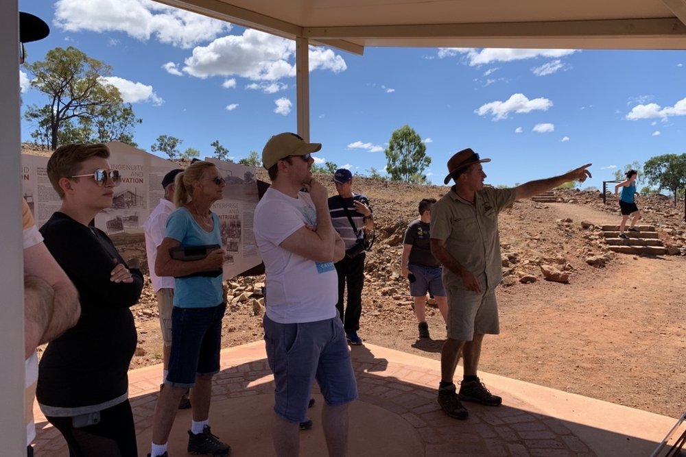 The guide talking the group through an outback stop