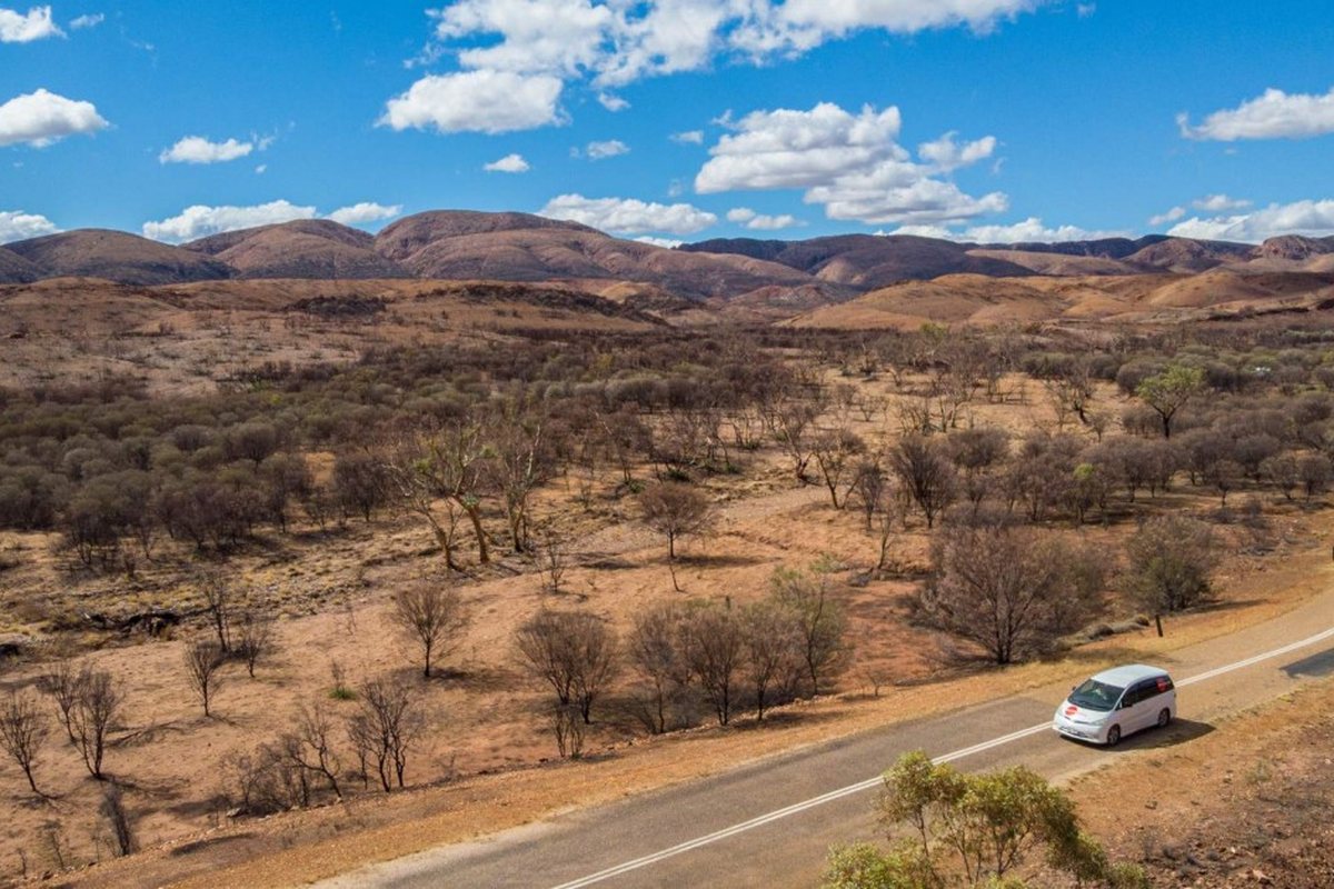 A Spaceships campervan on an outback highway seen from above