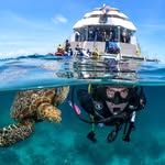 Superyacht above, diver below