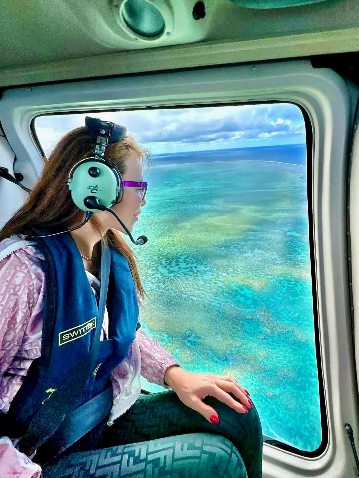 Helicopter window, turquoise reef below