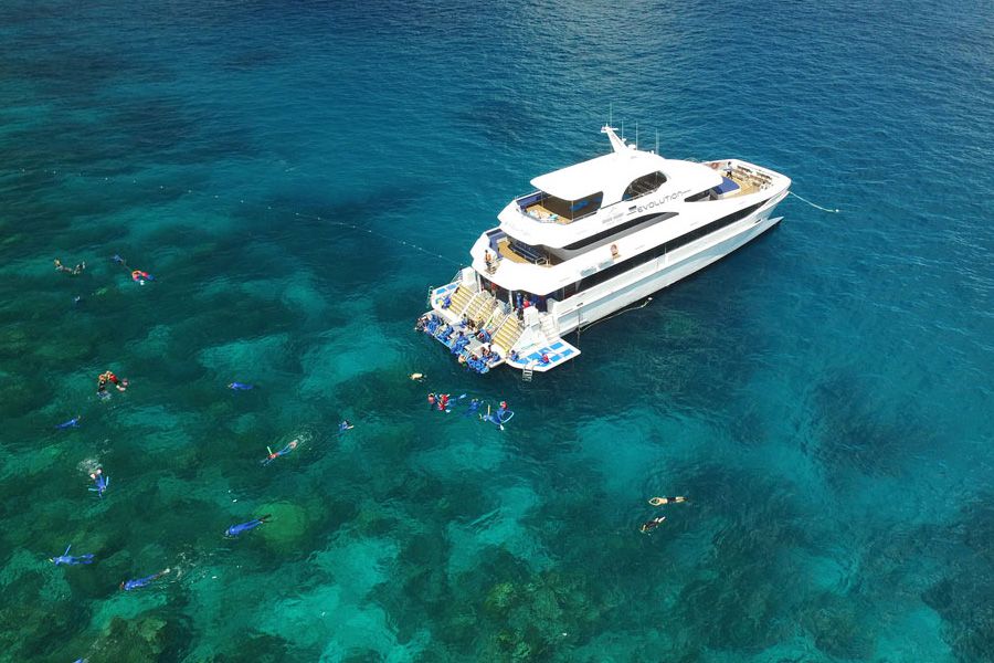 Boat with snorkellers, turquoise water