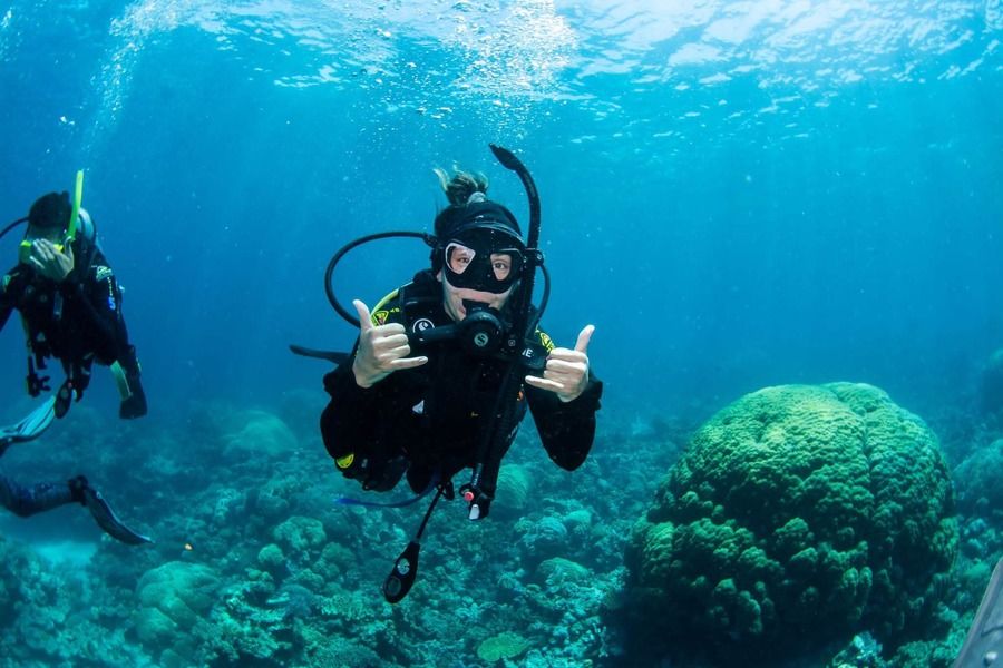 Introductory scuba divers with an instructor on the Great Barrier Reef from Cairns
