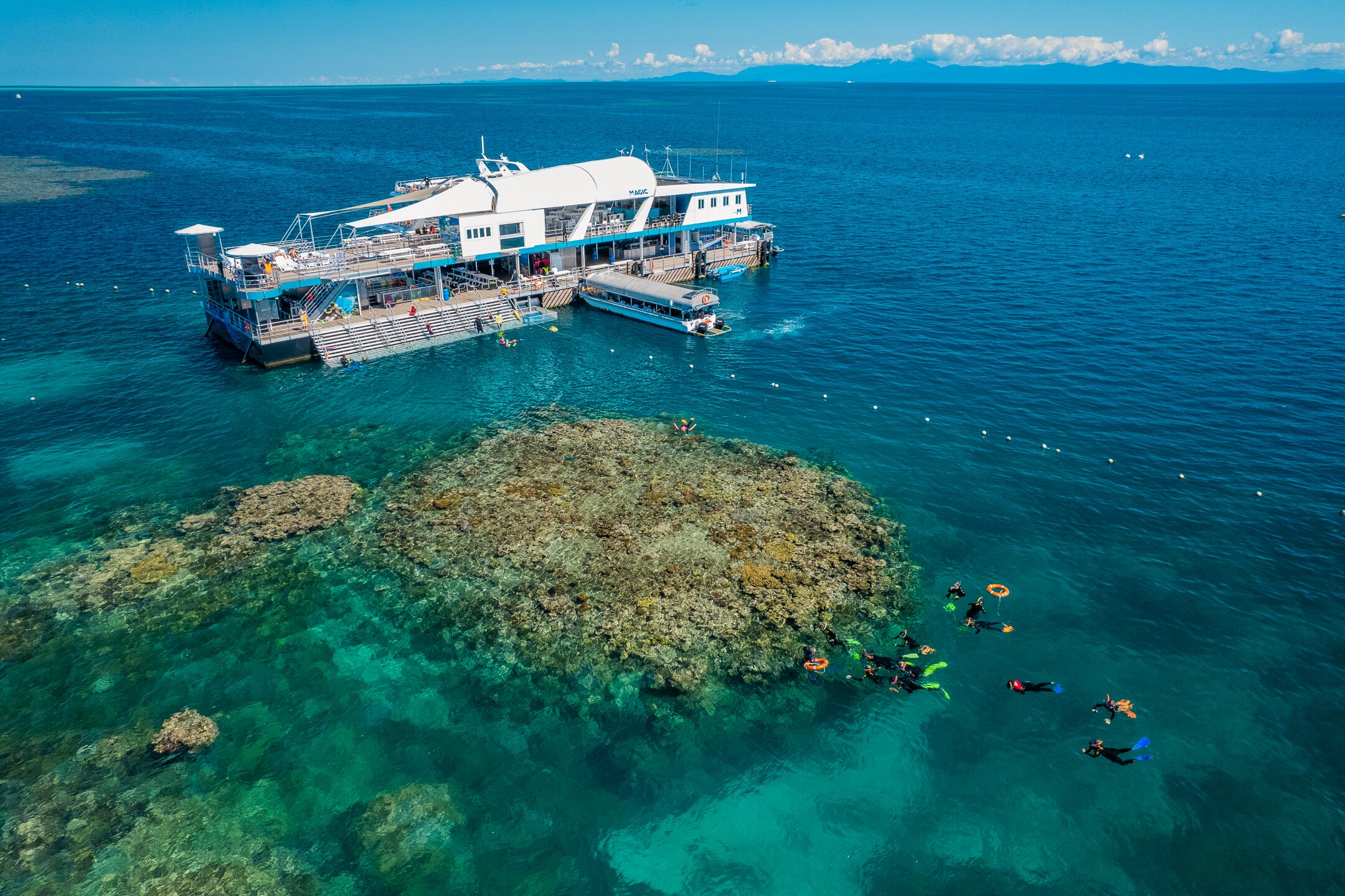 A reef pontoon moored at Moore Reef off Cairns with shaded decks