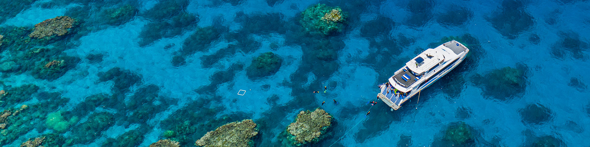 Aerial view, boat anchored at reef
